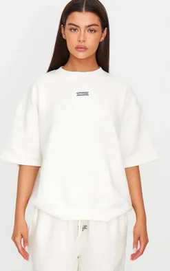 PRETTYLITTLETHING Cream Badge Detail Oversized Short Sleeve Sweatshirt