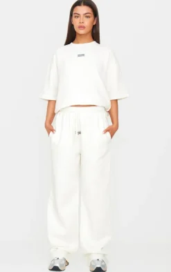 PRETTYLITTLETHING Cream Badge Detail Oversized Short Sleeve Sweatshirt