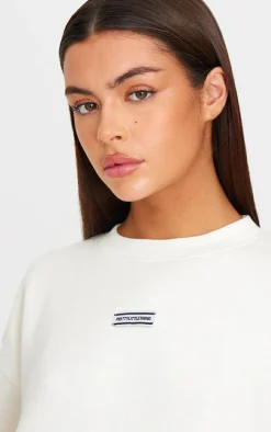 PRETTYLITTLETHING Cream Badge Detail Oversized Short Sleeve Sweatshirt