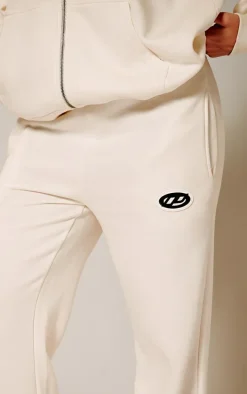 PRETTYLITTLETHING Cream Contrast Logo Badge Wide Leg Sweatpants