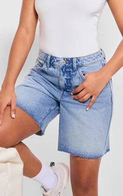 PRETTYLITTLETHING Mid Blue Wash Raw Hem Longline Loose Fit Denim Shorts