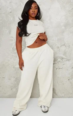 PRETTYLITTLETHING Plus Cream Contrast Embroidery Low Rise Wide Leg Sweatpants