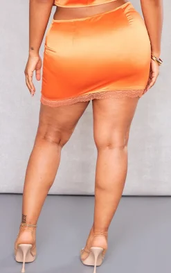 Shape Orange Satin Asymmetric Lace Hem Mini Skirt